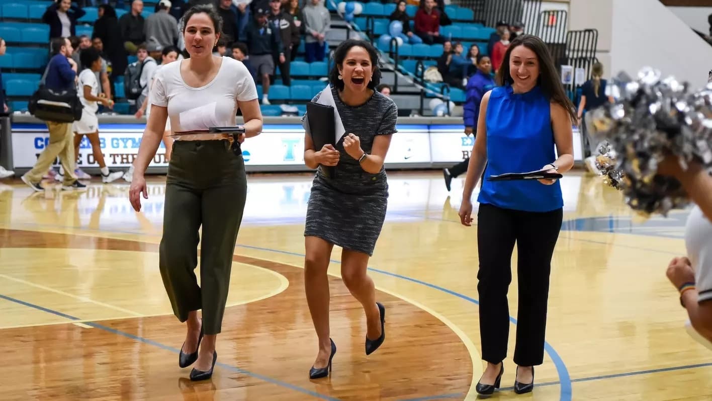 Coaching staff walking onto the court before a game